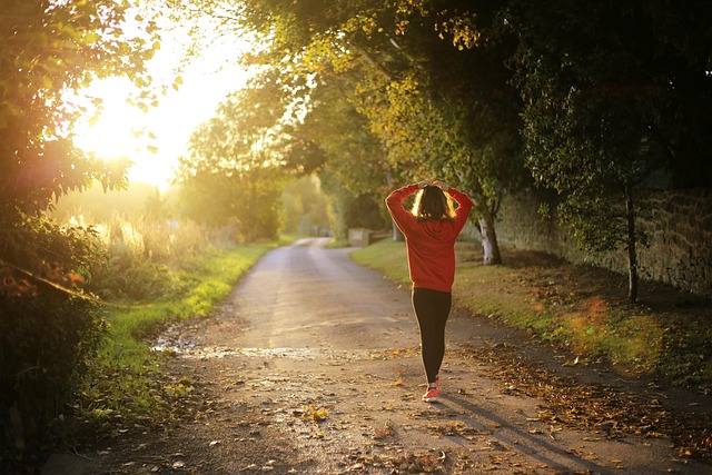Woman walking on sunlit path